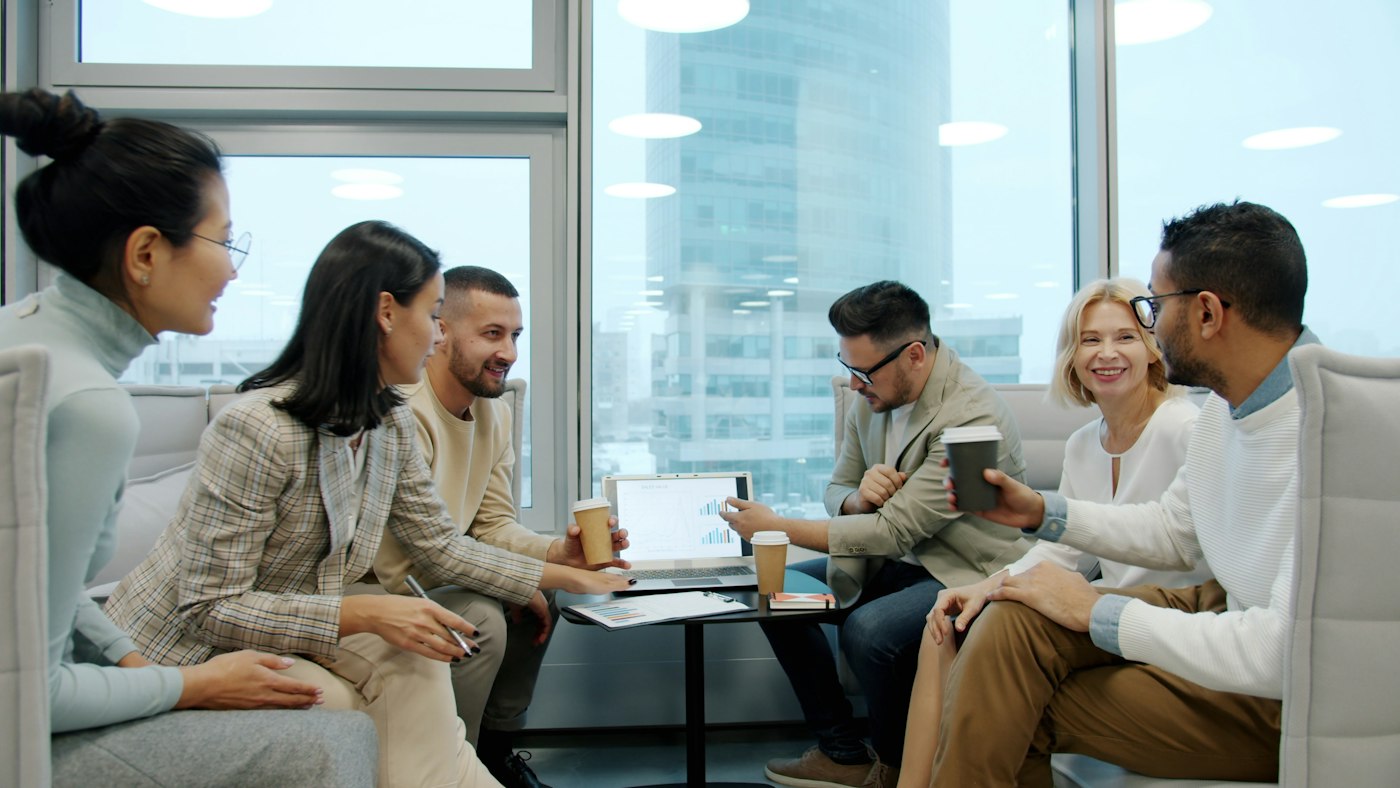 Leadership team discussing market progress in a city office
